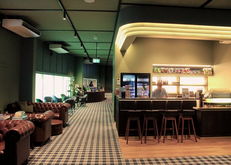 The clubhouse lounge with leather chesterfields and the bar